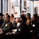 many people sitting on chairs and looking forward :audience