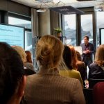 many people sitting on chair and looking at front ,while the picture is taken from thier backs ,